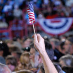 Tiny American flag in crowd at political rally