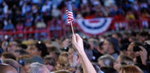 Tiny American flag in crowd at political rally
