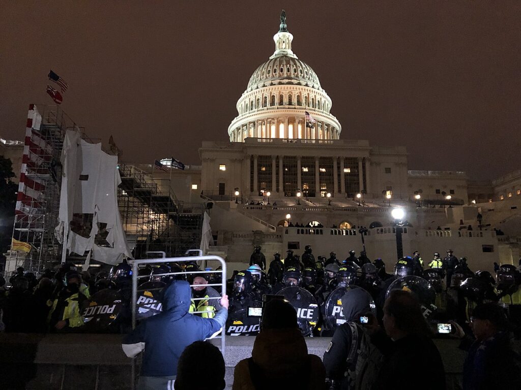 Riot police and protesters outside United States Capitol on the evening of Jan. 6, 2021